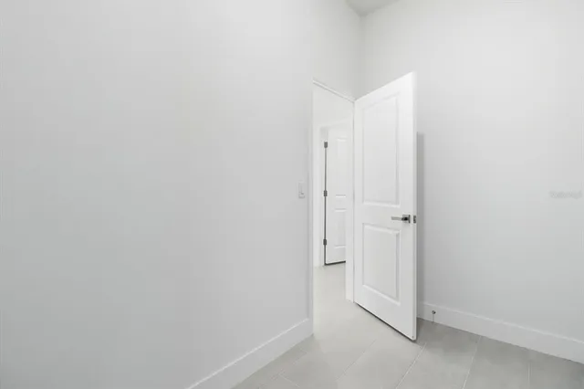 a view of an empty room with closet and a ceiling fan