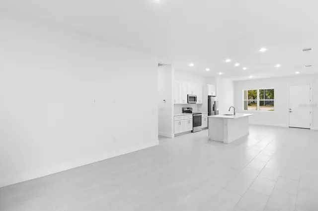a view of kitchen with stainless steel appliances cabinets