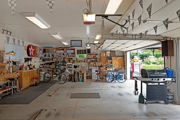 a view of a dining room and livingroom with furniture wooden floor a chandelier
