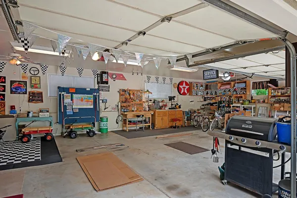 a kitchen with stainless steel appliances a sink a stove a refrigerator cabinets and a window