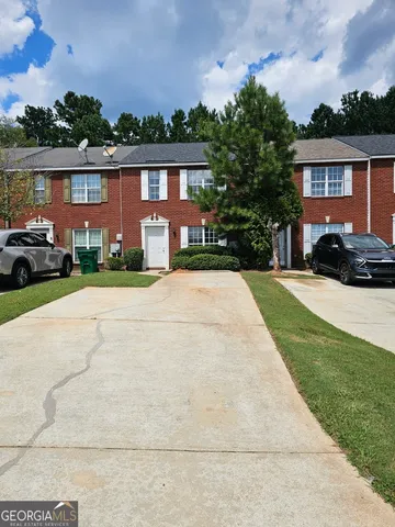 a view of house with yard and green space