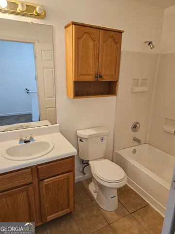 a bathroom with a sink a toilet and bathtub