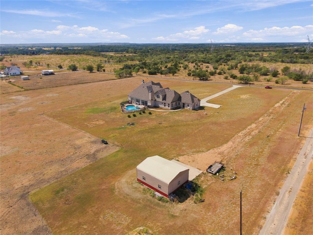 1180 Wiggins Road Maypearl, TX 76064 - Photo 40 of 40 A bird's-eye view capturing the pool, home, and outbuilding together, showing just how much this property has to offer.