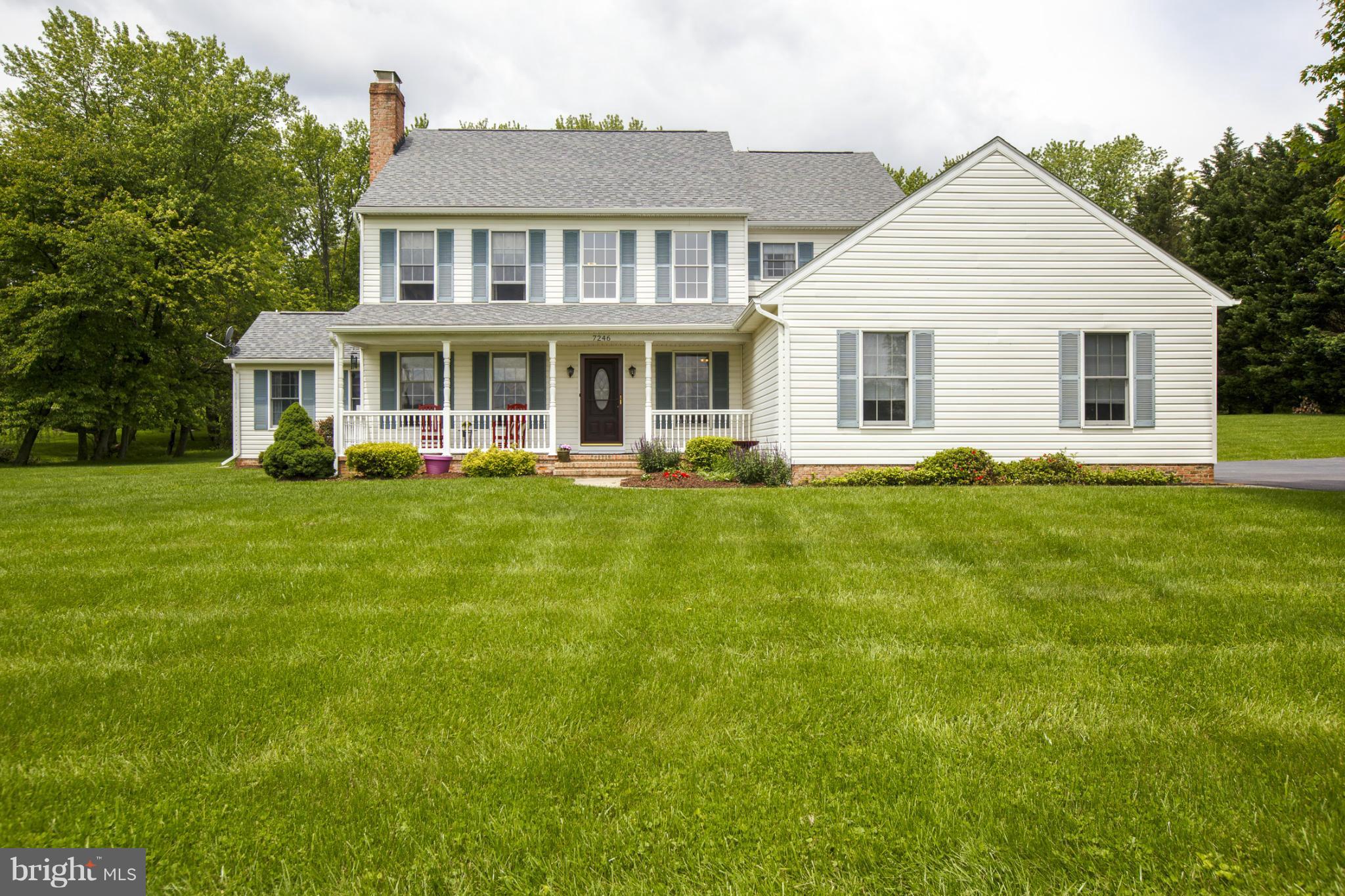 7246 Bowers Road Frederick, MD 21702 - Photo 1 of 30 a front view of a house with a garden and trees