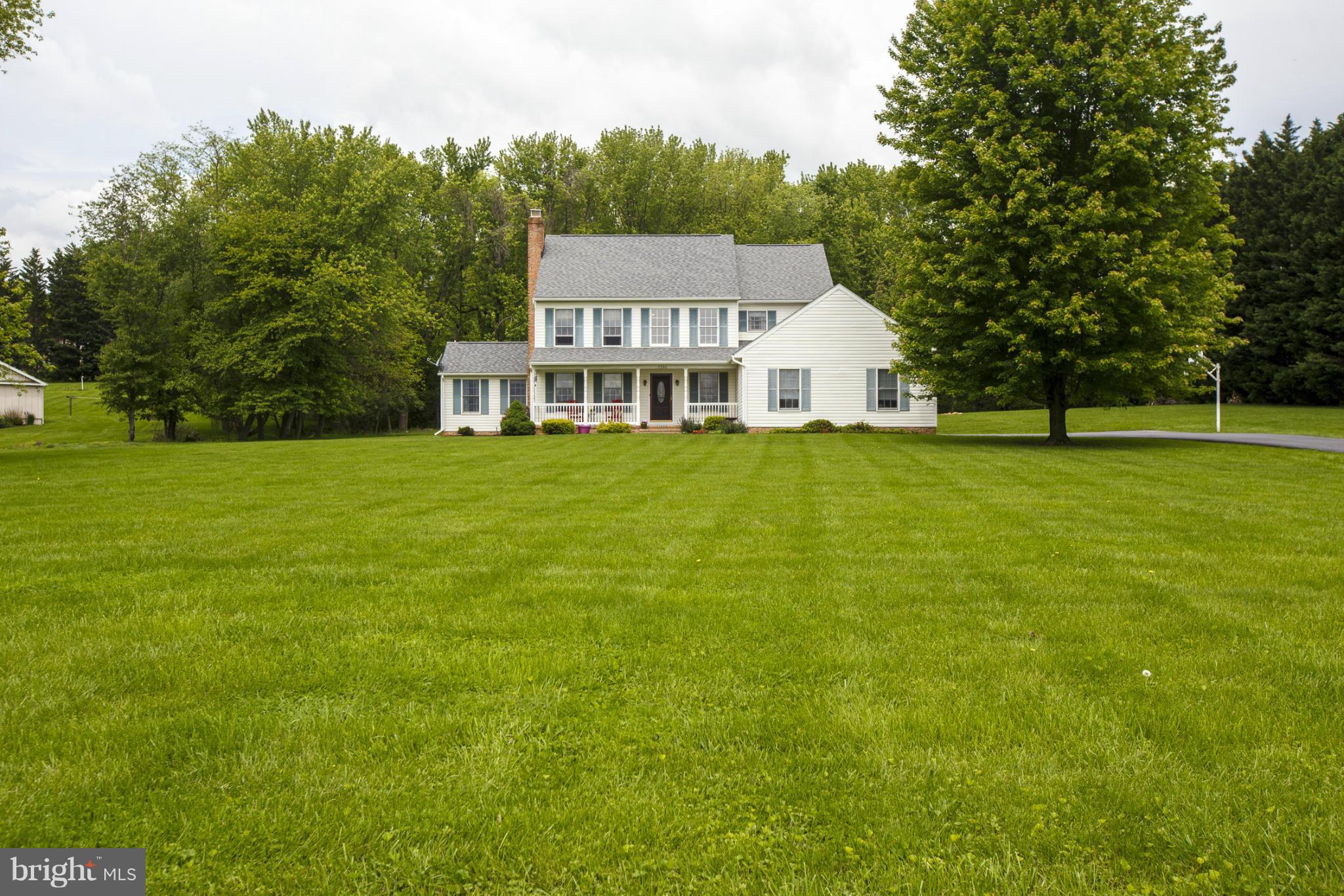 7246 Bowers Road Frederick, MD 21702 - Photo 2 of 30 a view of a big house with a big yard and large trees