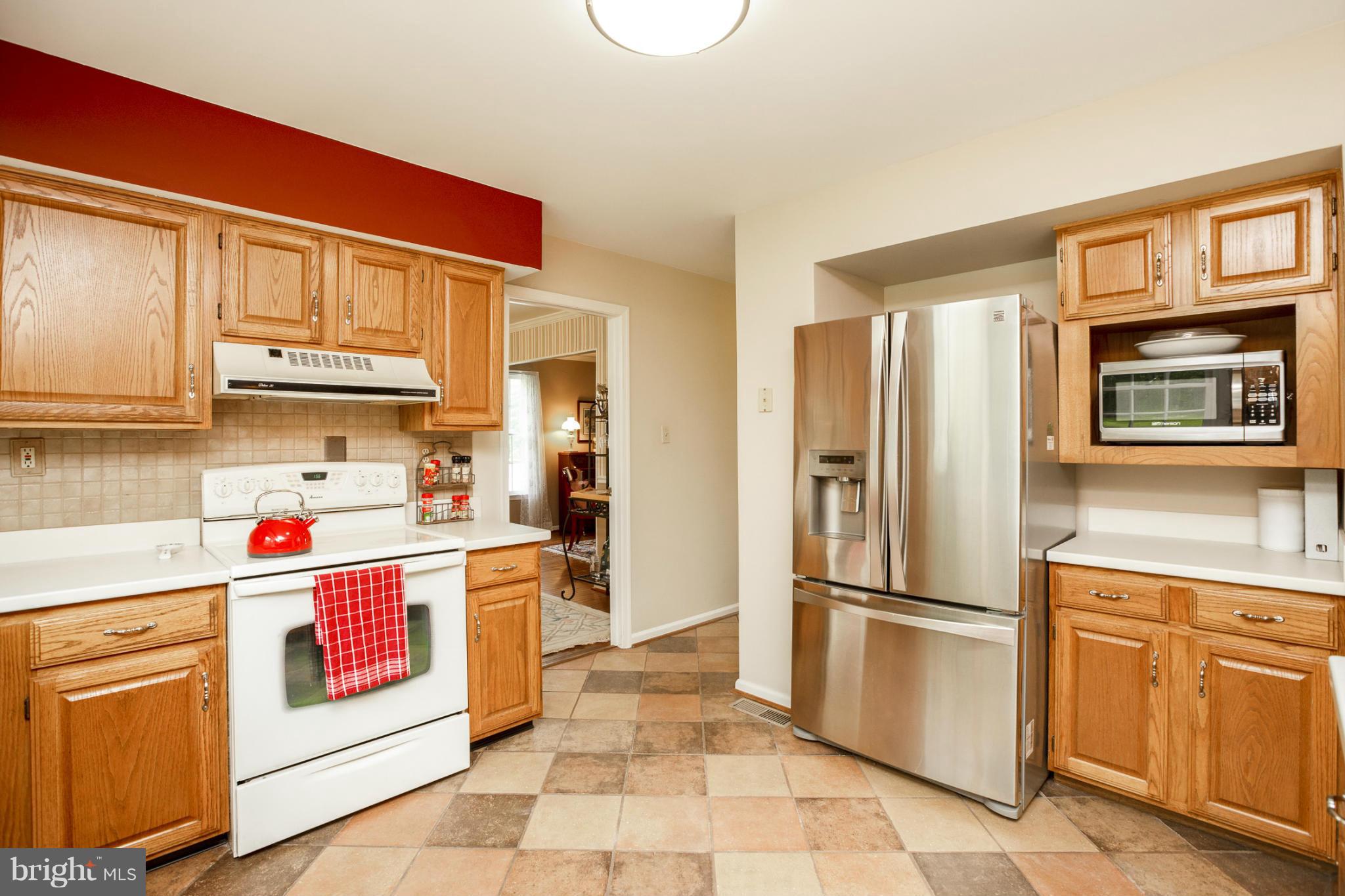 7246 Bowers Road Frederick, MD 21702 - Photo 13 of 30 a kitchen with stainless steel appliances granite countertop a refrigerator and a stove top oven