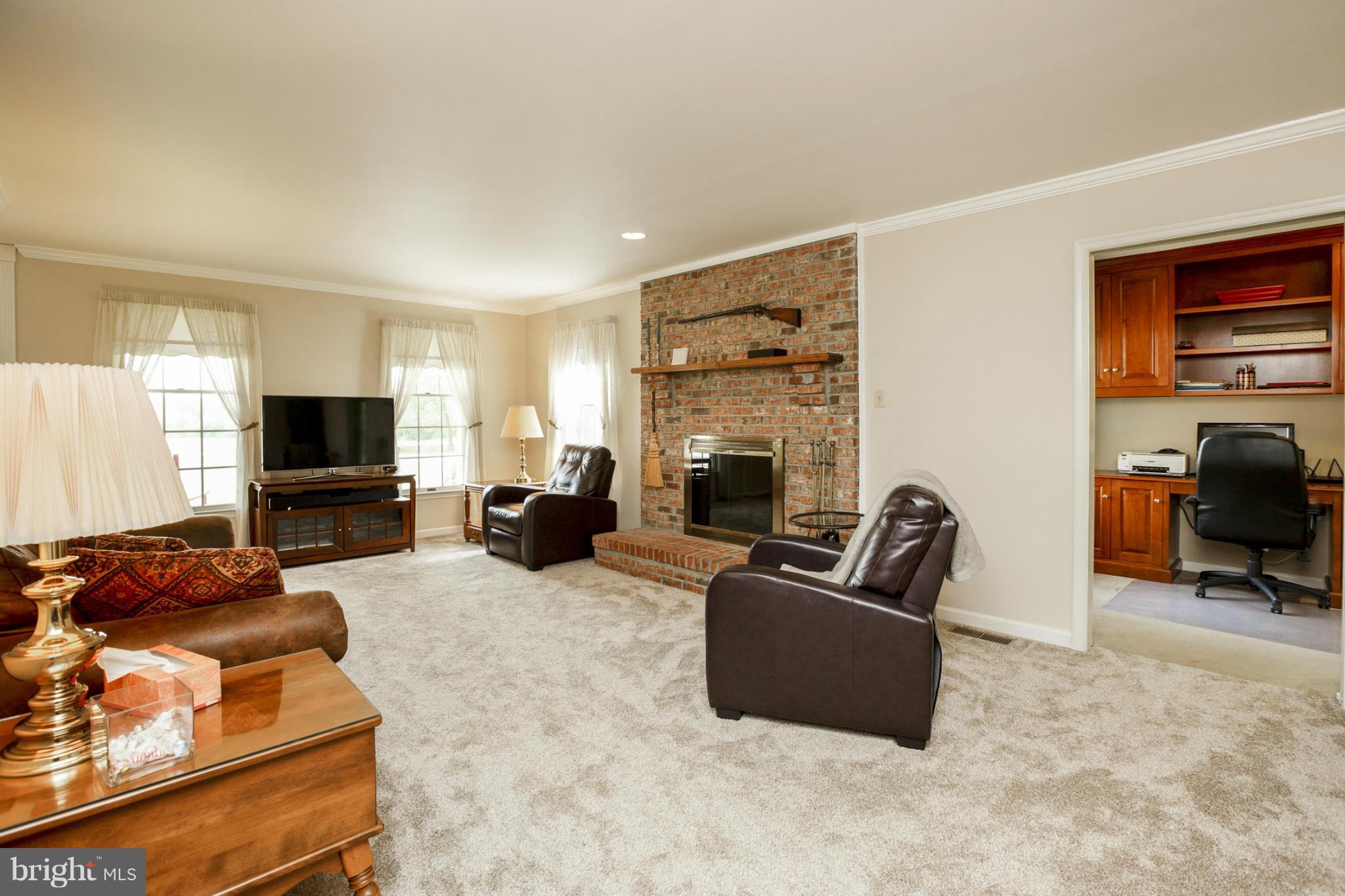 7246 Bowers Road Frederick, MD 21702 - Photo 17 of 30 a living room with furniture a flat screen tv and a fireplace