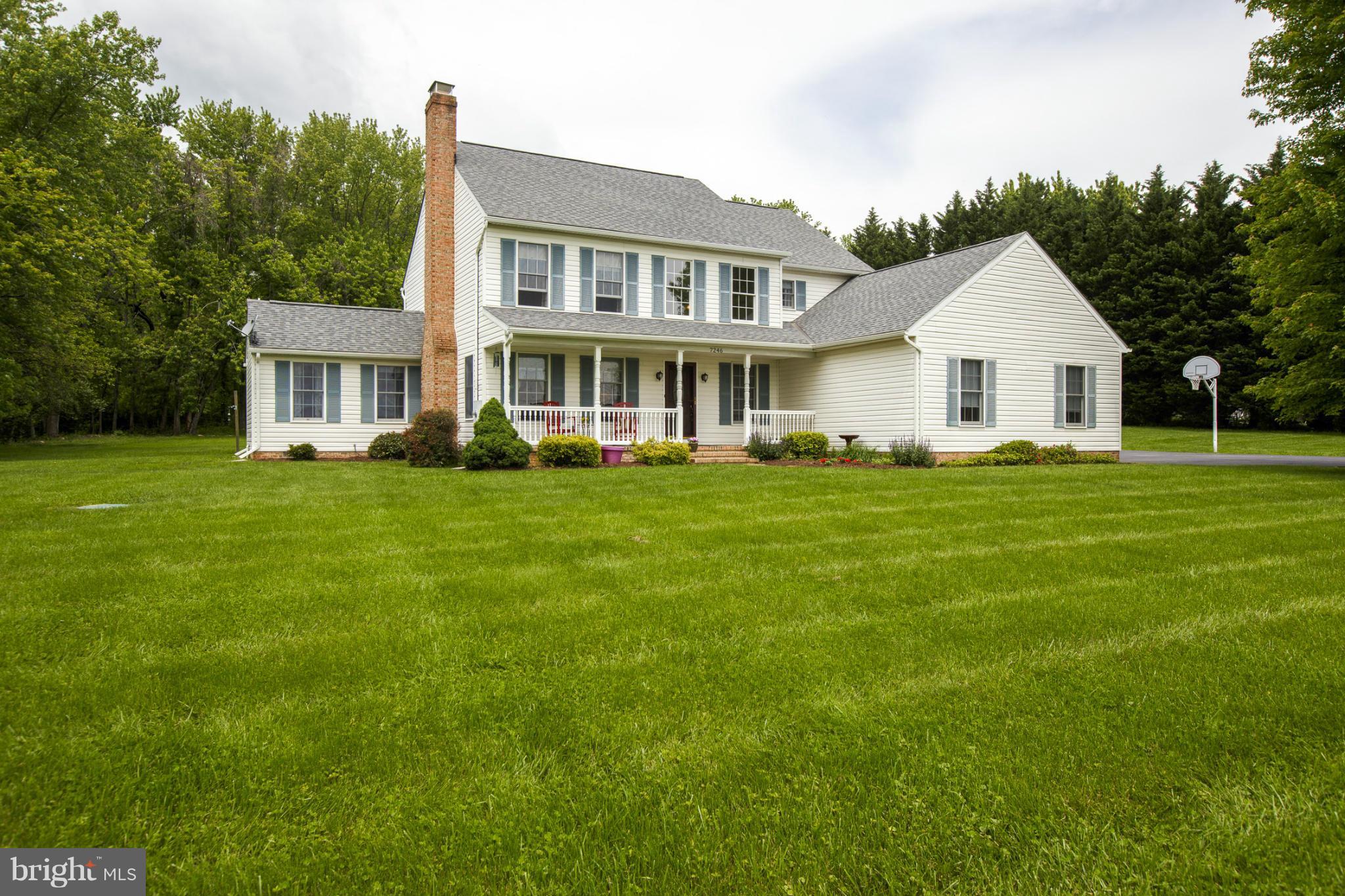 7246 Bowers Road Frederick, MD 21702 - Photo 3 of 30 a white house with a big yard and potted plants in front of it