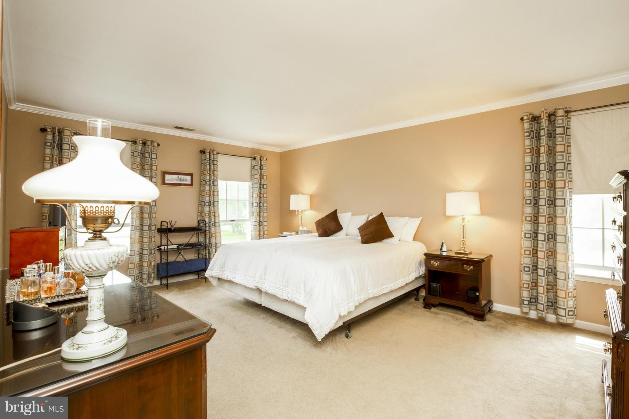 7246 Bowers Road Frederick, MD 21702 - Photo 23 of 30 a spacious bedroom with a bed and a table in it