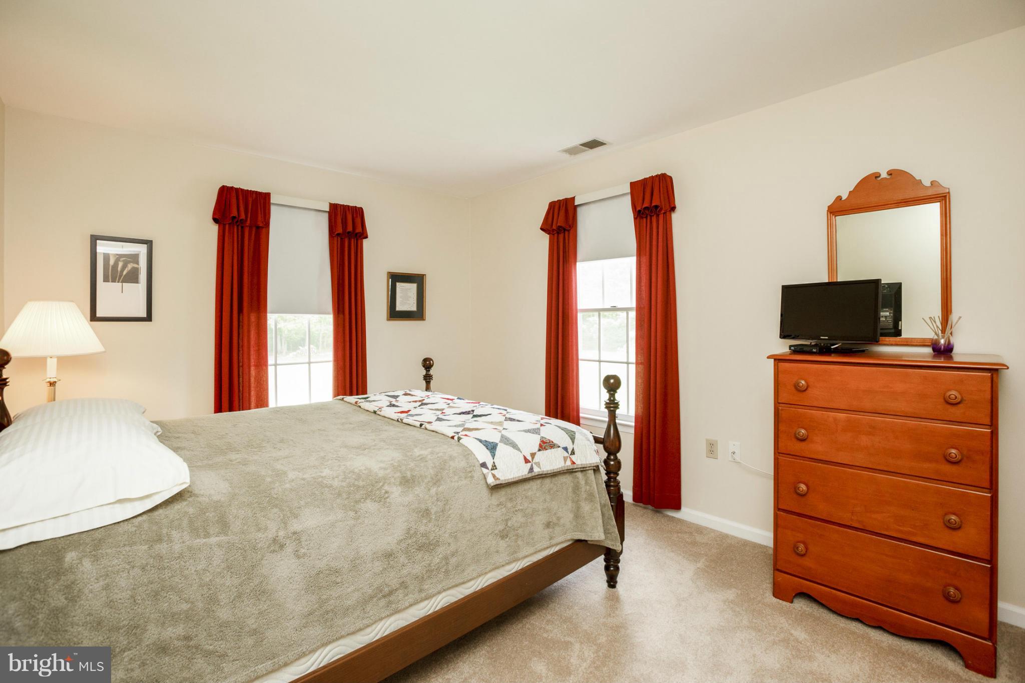 7246 Bowers Road Frederick, MD 21702 - Photo 29 of 30 a bedroom with a bed and a flat tv screen on dresser