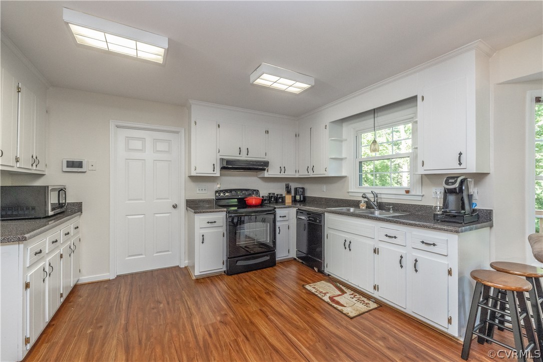 7436 Drexelbrook Road Chesterfield, VA 23832 - Photo 11 of 31 a kitchen with granite countertop a sink cabinets and wooden floor
