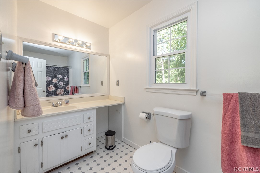 7436 Drexelbrook Road Chesterfield, VA 23832 - Photo 26 of 31 a bathroom with a sink a mirror a toilet and a window