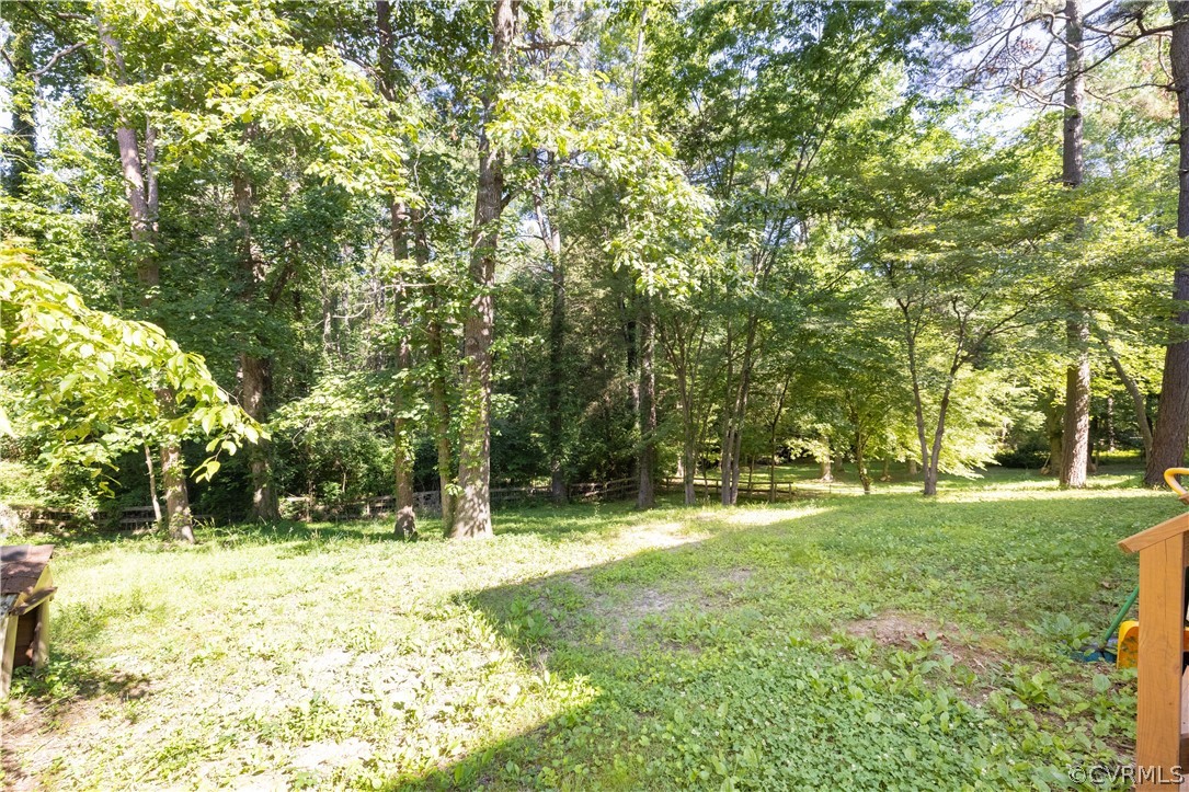 7436 Drexelbrook Road Chesterfield, VA 23832 - Photo 30 of 31 a backyard of a house with a yard and large trees
