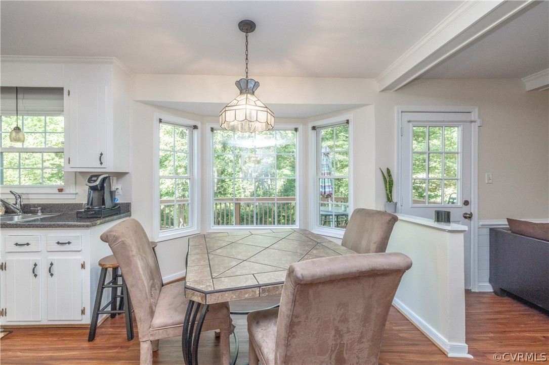 7436 Drexelbrook Road Chesterfield, VA 23832 - Photo 9 of 31 a dining room with furniture a chandelier and wooden floor