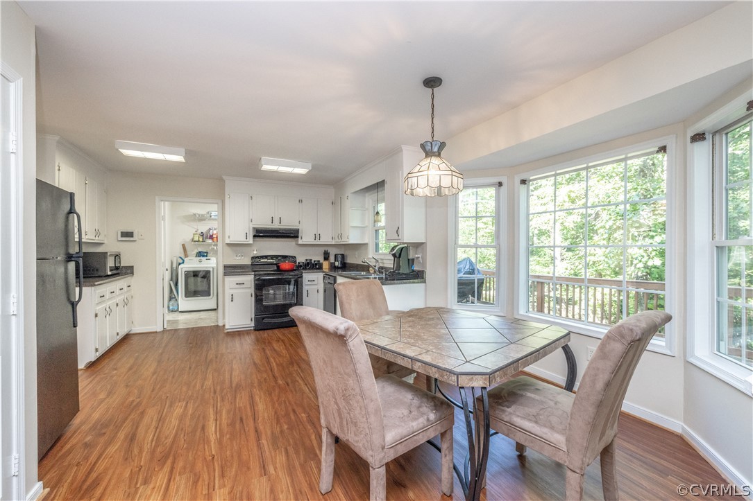 7436 Drexelbrook Road Chesterfield, VA 23832 - Photo 10 of 31 a view of a dining room and livingroom with furniture wooden floor a chandelier