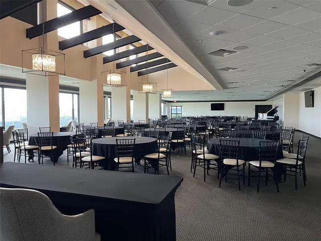 a dining room with furniture and a floor to ceiling window