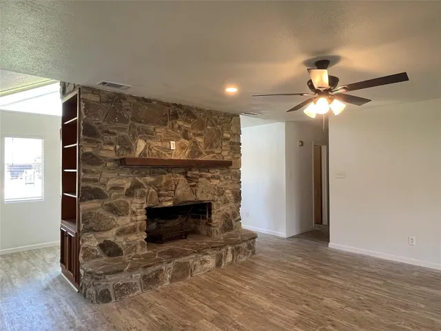 a room with fireplace and wooden floor