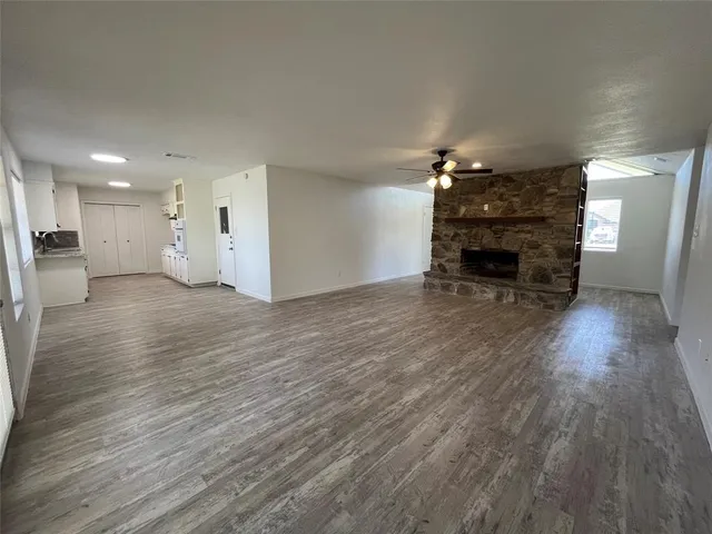 a large white kitchen with granite countertop a sink