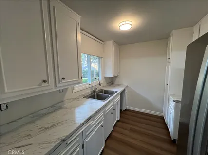 a view of empty room with wooden floor and fireplace