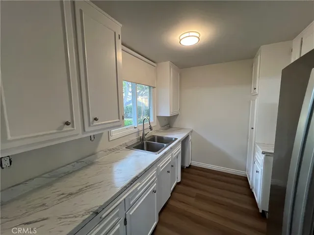 a view of empty room with wooden floor and fireplace