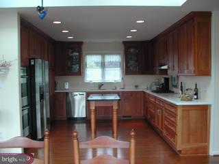 310 High Ridge Road Greenville, DE 19807 - Photo 4 of 6 a kitchen with stainless steel appliances granite countertop a refrigerator a sink dishwasher a stove a microwave oven with cabinets and wooden floor
