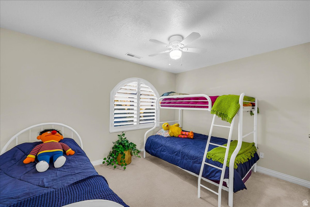 150 South Crystal Street, Unit 31 St. George, UT 84770 - Photo 18 of 20 Carpeted bedroom featuring a textured ceiling and a ceiling fan