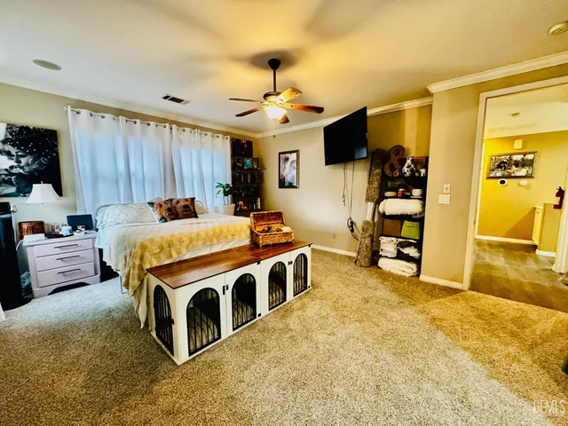 a bed room with a bed furniture and a flat screen tv