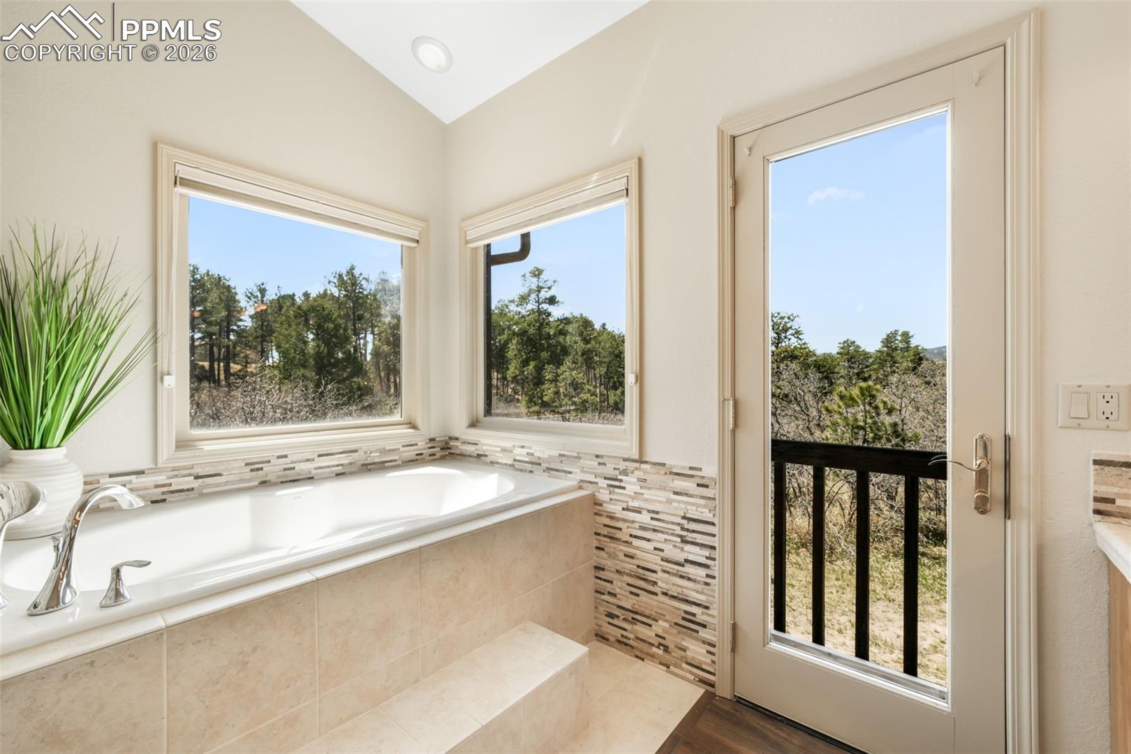 19790 Beacon Lite Road Monument, CO 80132 - Photo 19 of 50 Soaking tub with tile surround and polished chrome fixtures