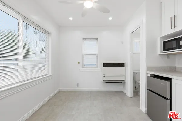 a bathroom with a granite countertop sink and white cabinets