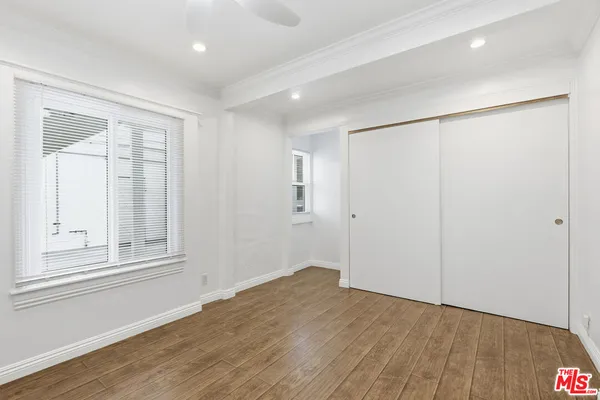 a view of an empty room and wooden floor