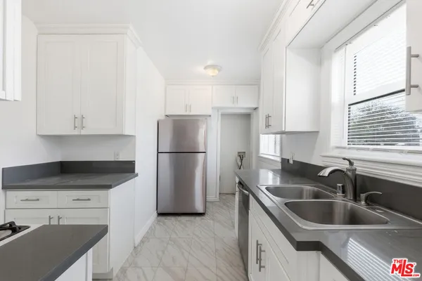 a bathroom with a shower and a sink
