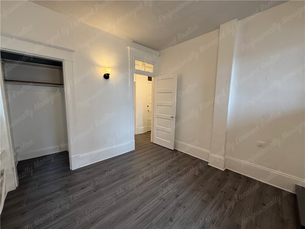 44 West High Street, Unit B Springfield, OH 45502 - Photo 28 of 31 This inviting room features elegant wood flooring and a spacious closet, perfect for comfortable living.
