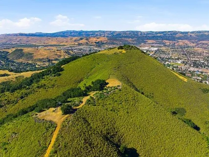 a view of a large mountain with mountains in the background