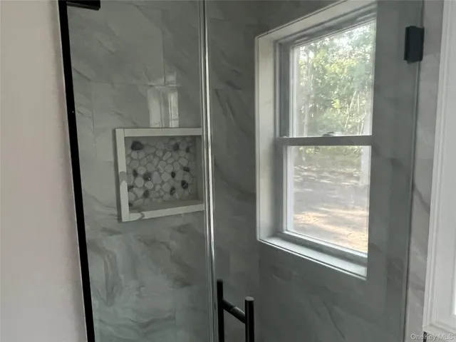 a bathroom with a glass shower door