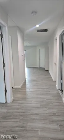 a view of a livingroom with wooden floor and staircase