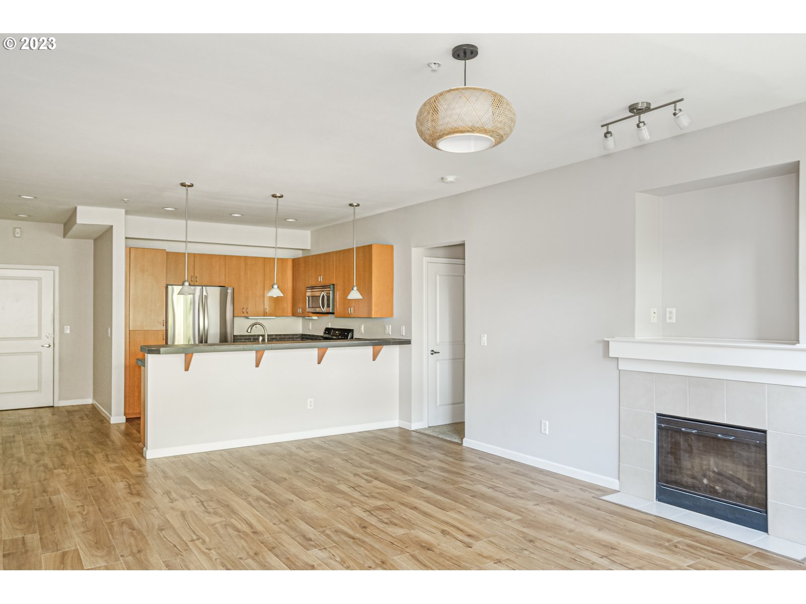 8712 North Decatur Street, Unit 201 Portland, OR 97203 - Photo 12 of 40 a view of kitchen and empty room with wooden floor