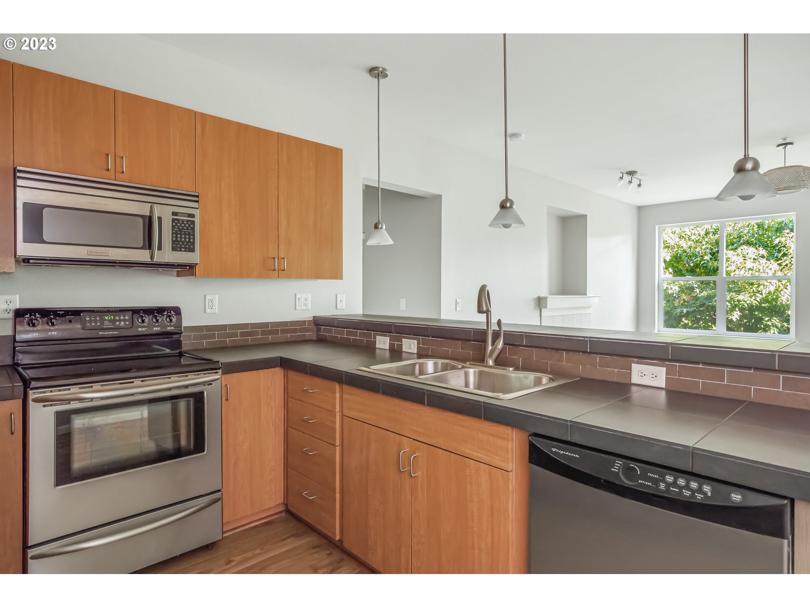 8712 North Decatur Street, Unit 201 Portland, OR 97203 - Photo 16 of 40 a kitchen with a sink stove and microwave