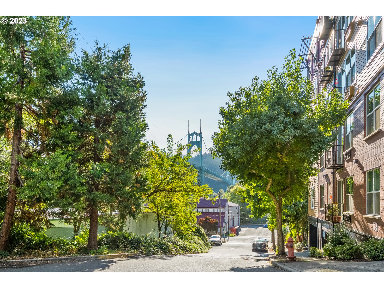 8712 North Decatur Street, Unit 201 Portland, OR 97203 - Photo 2 of 40 a view of a city with flower plants and wooden fence