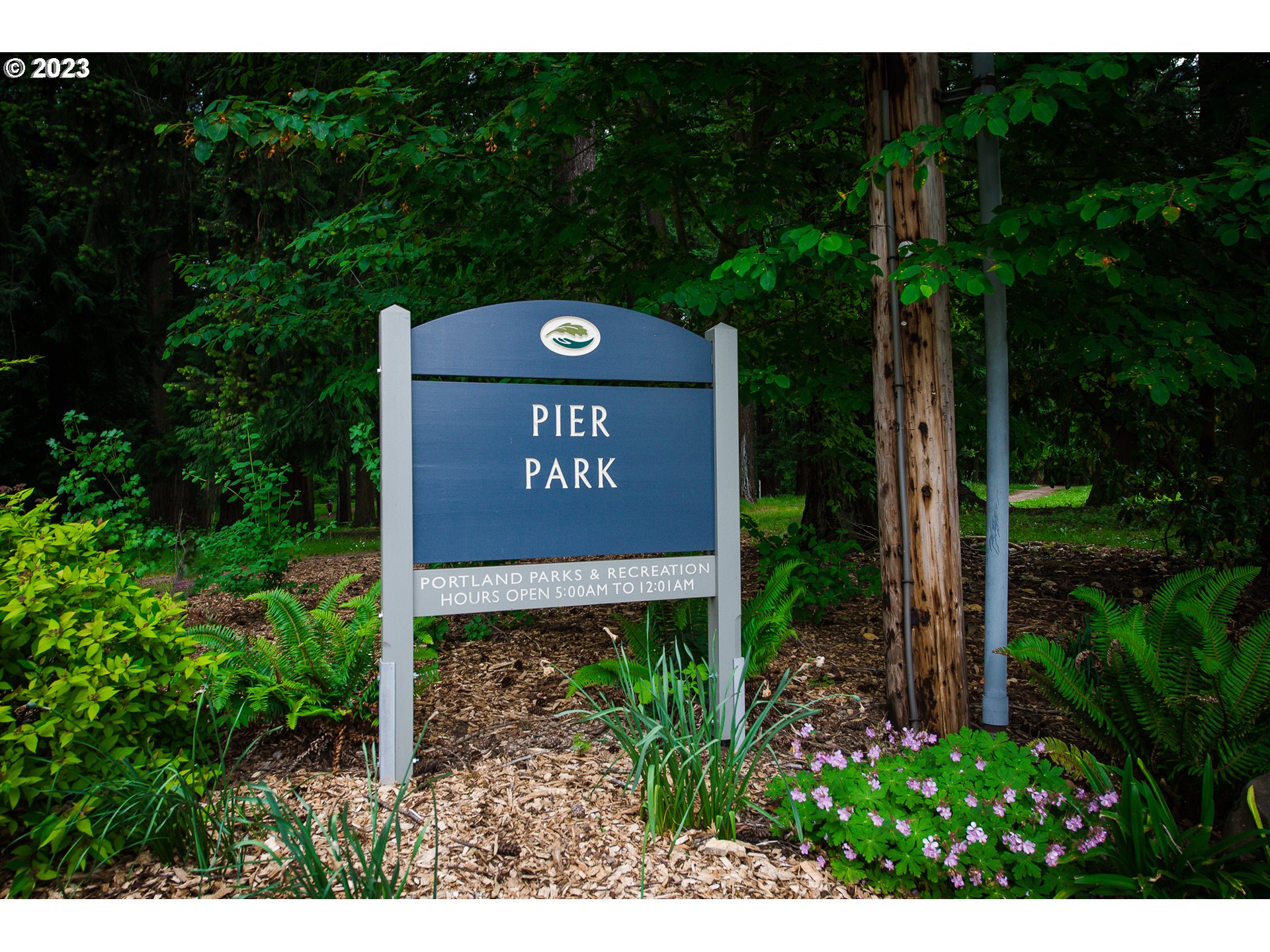 8712 North Decatur Street, Unit 201 Portland, OR 97203 - Photo 40 of 40 a sign that is sitting in front of flowers