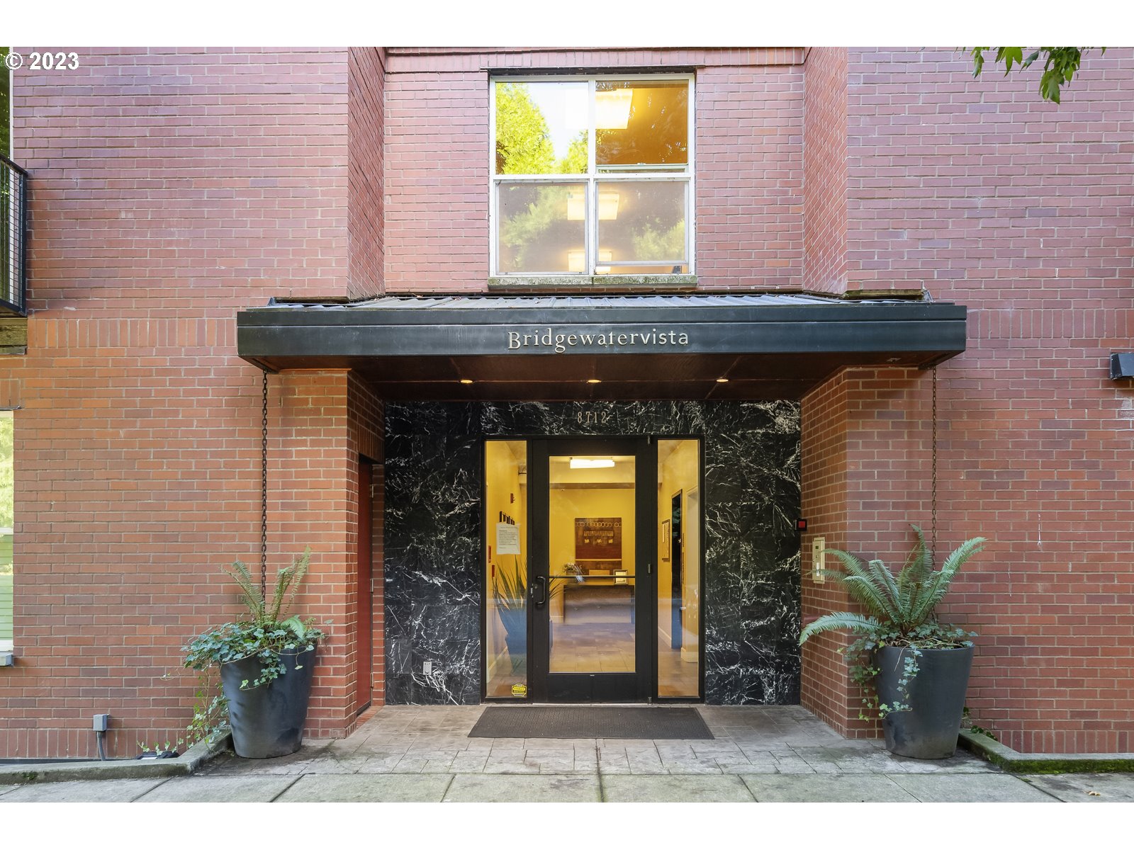 8712 North Decatur Street, Unit 201 Portland, OR 97203 - Photo 4 of 40 a view of a brick house with potted plants