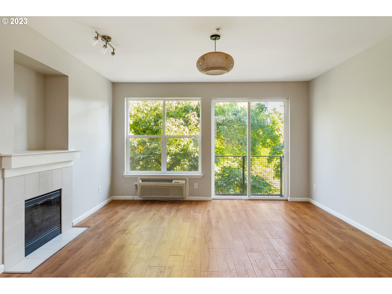 8712 North Decatur Street, Unit 201 Portland, OR 97203 - Photo 5 of 40 a view of an empty room with a window and wooden floor