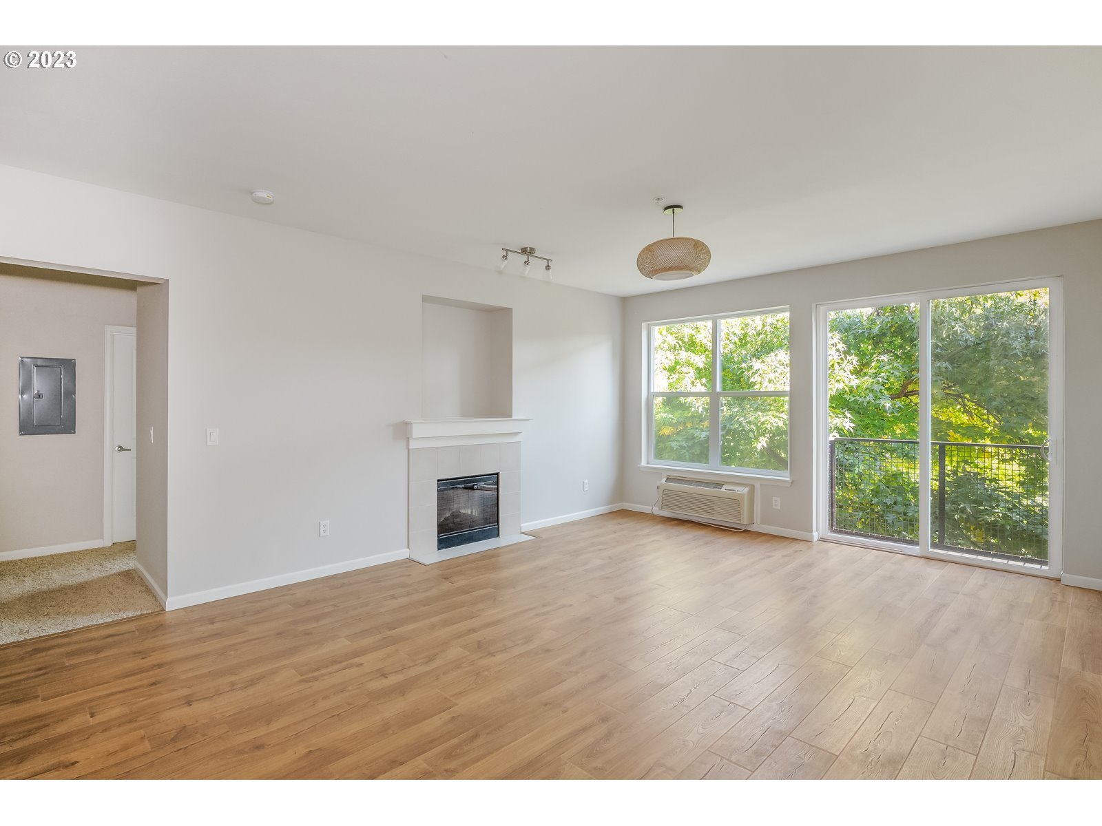 8712 North Decatur Street, Unit 201 Portland, OR 97203 - Photo 7 of 40 a view of an empty room with wooden floor and a window