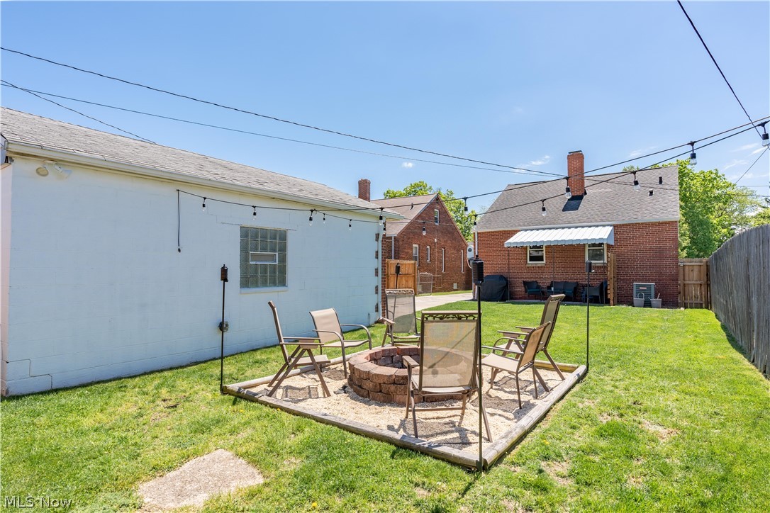 8320 Ackley Road Parma, OH 44129 - Photo 34 of 36 View of yard featuring a patio area and a fire pit