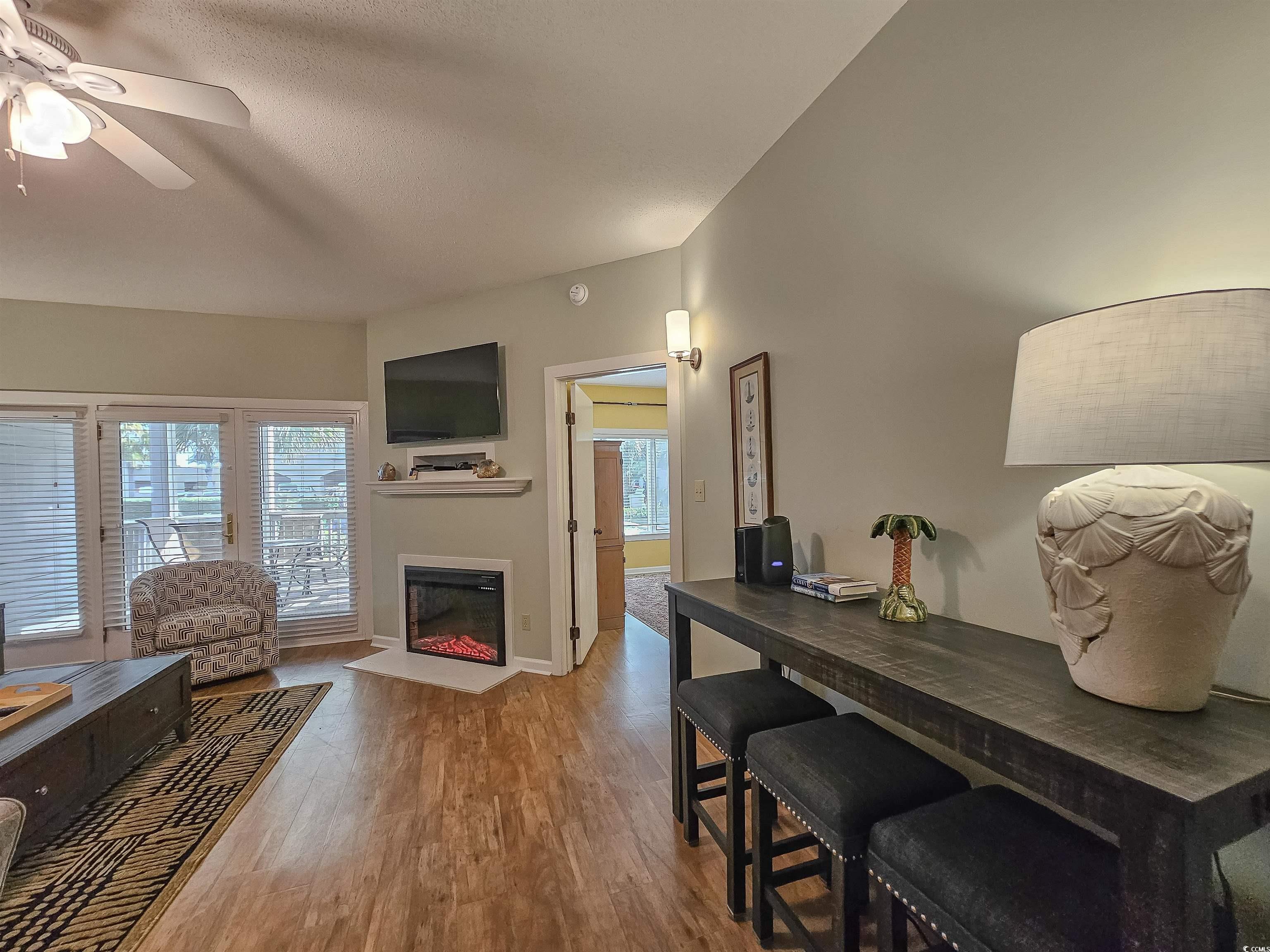 709 Appleby Way, Unit 7C Myrtle Beach, SC 29572 - Photo 8 of 40 Living area with LVP flooring, electric fireplace, and ceiling fan
