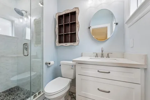 a bathroom with a toilet a sink and a mirror