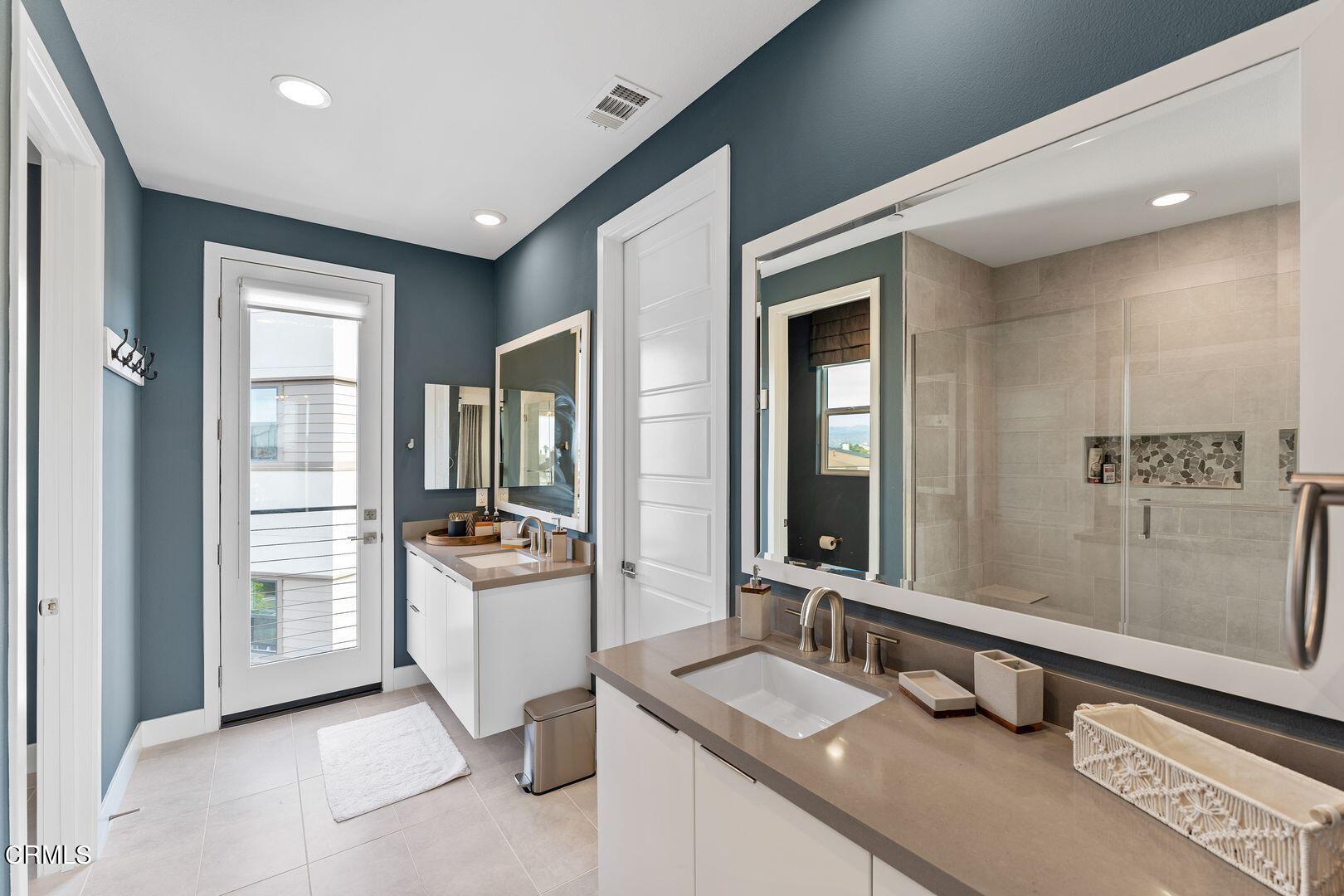 1028 Harbor Boulevard Oxnard, CA 93035 - Photo 36 of 48 a bathroom with a granite countertop sink a mirror and a bathtub