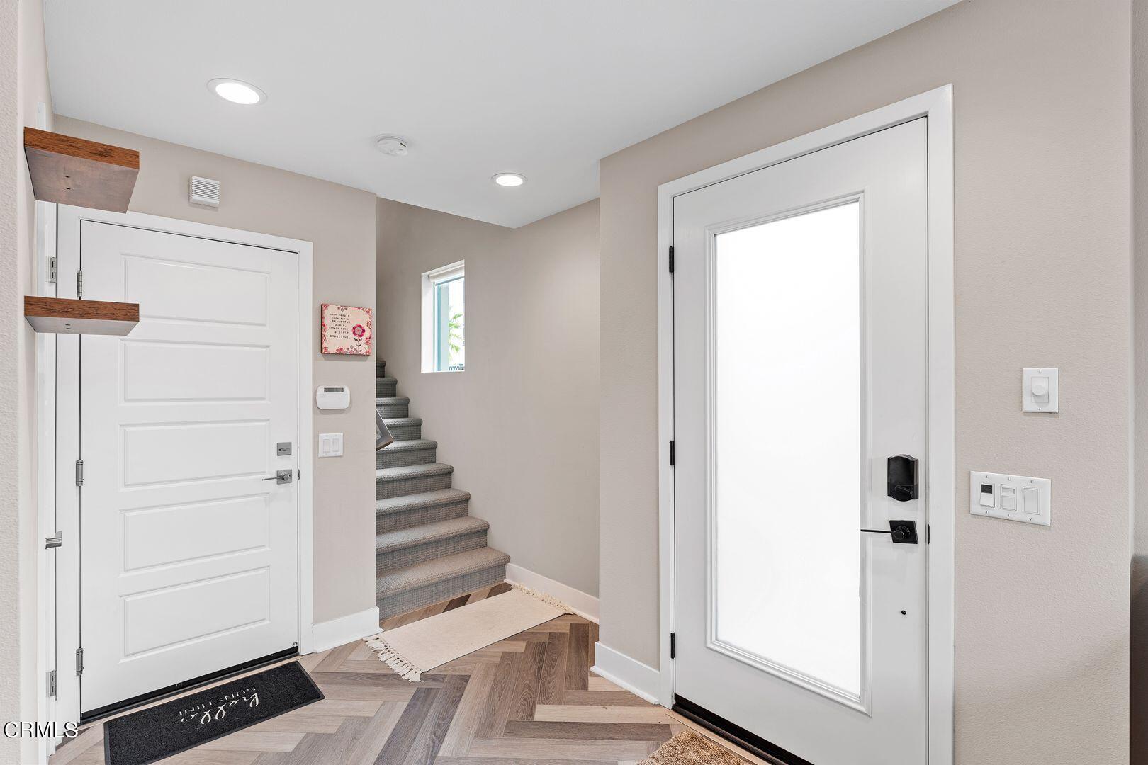 1028 Harbor Boulevard Oxnard, CA 93035 - Photo 6 of 48 a view of a hallway with entryway wooden floor and front door