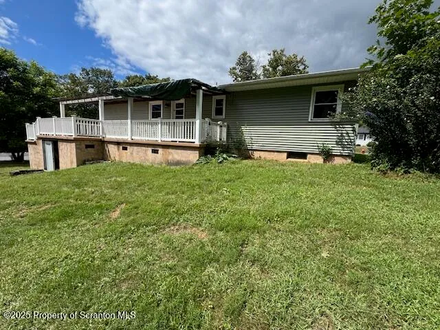 a house with green field in front of it