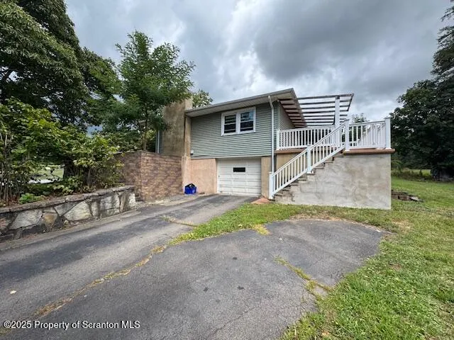 a view of a house with a yard and garage