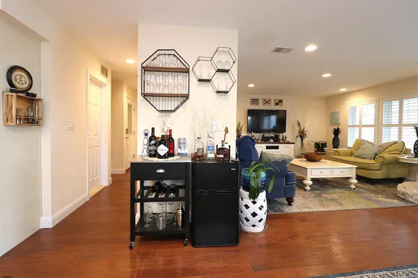 a living room with furniture and a mirror